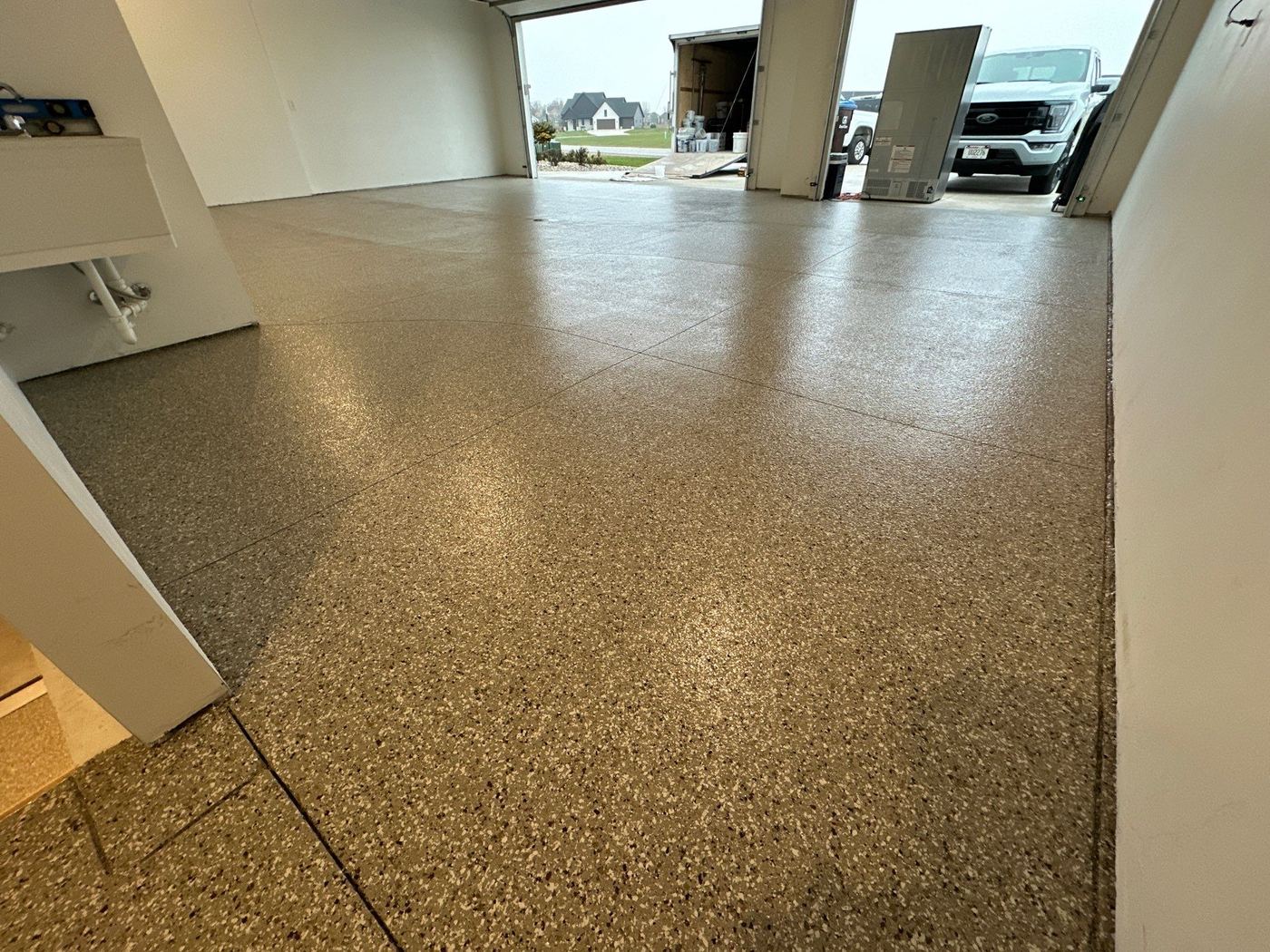 2-car garage with Penntek polyurea silver grey color flake coating — StraightLineCoatings