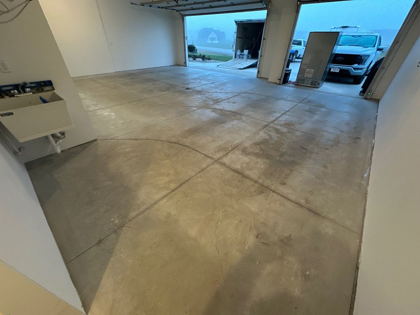 Before: bare stained concrete 2-car garage floor
